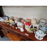 A COLLECTION OF NOVELTY TEA POTS OF HOUSE AND OTHER FORMS