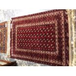 A GOOD QUALITY AFGHAN BOKHARA RUG. 183 x 133cms