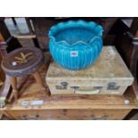 A TURQUOISE POTTERY PLANTER, A VELLUM SUITCASE TOGETHER WITH A STOOL PAINTED WITH WHEAT EARS