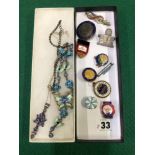 A SILVER GEMSET PENDANT, A BUTTERFLY COSTUME NECKLACE,AND VARIOUS BADGES PINS AND BROOCHES.