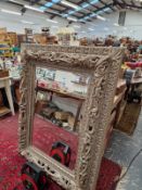 A LARGE DECORATIVE WALL MIRROR.