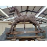 A TODDLERS BROWN PAINTED ROCKING HORSE