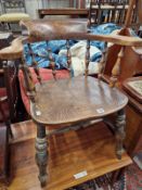 A VICTORIAN SMOKERS BOW ARM CHAIR.