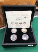 A BOXED SET OF FOUR SILVER PROOF £5 COINS.