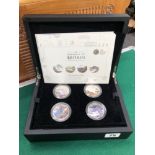 A BOXED SET OF FOUR SILVER PROOF £5 COINS.