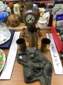 A SPELTER CASED CLOCK, THREE TRENCH ART SHELL CASES AND A COLD CAST MOTHER SUCKLING TWO PUPPIES