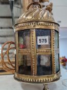 A BRASS AND COLOURED GLASS ELECTRIC LANTERN