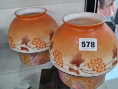 A PAIR OF FROSTED MILK GLASS LIGHT SHADES WITH ORANGE DECORATION