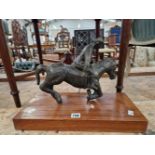 A BRONZE MODEL OF A POLO PLAYER ON WOOD PLINTH