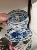AN 18th C. DELFT BLUE AND WHITE PLATE TOGETHER WITH A FAENZA BLUE AND WHITE BOWL INSCRIBED P