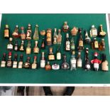 A QUANITY OF ORNAMENTAL VINTAGE COLLECTORS BOTTLES.