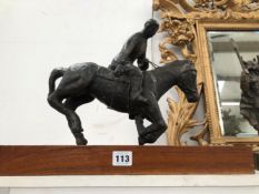 A BRONZE FIGURE OF A POLO PLAYER
