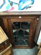 A GEORGIAN GLAZED OAK CORNER CABINET