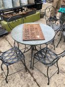 A MARBLE TOPPED GARDEN TABLE TOGETHER WITH EIGHT VARIOUS IRON GARDEN CHAIRS.