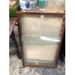 A COLLECTORS WALL CABINET WITH A GLASS FRONT OVER GLASS SHELVES