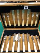 A SET OF ART DECO SILVER BLADED FISH KNIVES AND FORKS WITH IVORINE HANDLES IN A LOCKING CANTEEN.