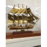 A BRASS MODEL OF THE FOUR MASTED SHIP J S ELCANO UNDER A RECTANGULAR DOME
