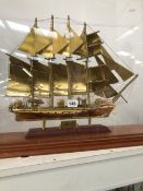 A BRASS MODEL OF THE FOUR MASTED SHIP J S ELCANO UNDER A RECTANGULAR DOME