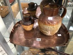 TWO TWO TONE BROWN SALTGLAZE JUGS TOGETHER WITH A COPPER TRAY