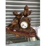 A LATE 19th C. FRENCH SPELTER AND MOTTLED RED MARBLE CLOCK WITH A LADY REACHING UP TO THE FOUNTAIN