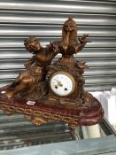 A LATE 19th C. FRENCH SPELTER AND MOTTLED RED MARBLE CLOCK WITH A LADY REACHING UP TO THE FOUNTAIN