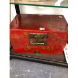 A CHINESE RED LACQUER TWO HANDLED TRUNK GILT WITH CHILDREN AT PLAY