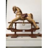 A SADDLED WOOD MINIATURE ROCKING HORSE