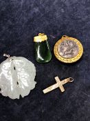 A 9ct GOLD CROSS, AN EASTERN HARDSTONE FISH PENDANT, A JADE PENDANT WITH A 18ct GOLD MOUNT, AND A