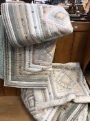 TWO HANDMADE QUILTS AND TWO MATCHING PILLOW COVERS.