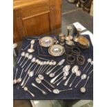 A QUANTITY OF HALLMARKED SILVER TO INCLUDE VARIOUS SPOONS, CANDLESTICKS, CRUETS, CONDIMENT DISHES,