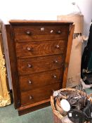 A VICTORIAN CARVED OAK FIVE DRAWER WELLINGTON CHEST
