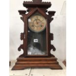 AN ANSONIA CLOCK STRIKING ON A COILED ROD AND IN A GLAZED WOODEN CASE