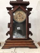 AN ANSONIA CLOCK STRIKING ON A COILED ROD AND IN A GLAZED WOODEN CASE