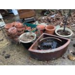 A STONEWARE PEDESTAL, A QUANTITY OF PLANT POTS, A BROWN GLAZED CORNER SINK AND A FIRE GRATE