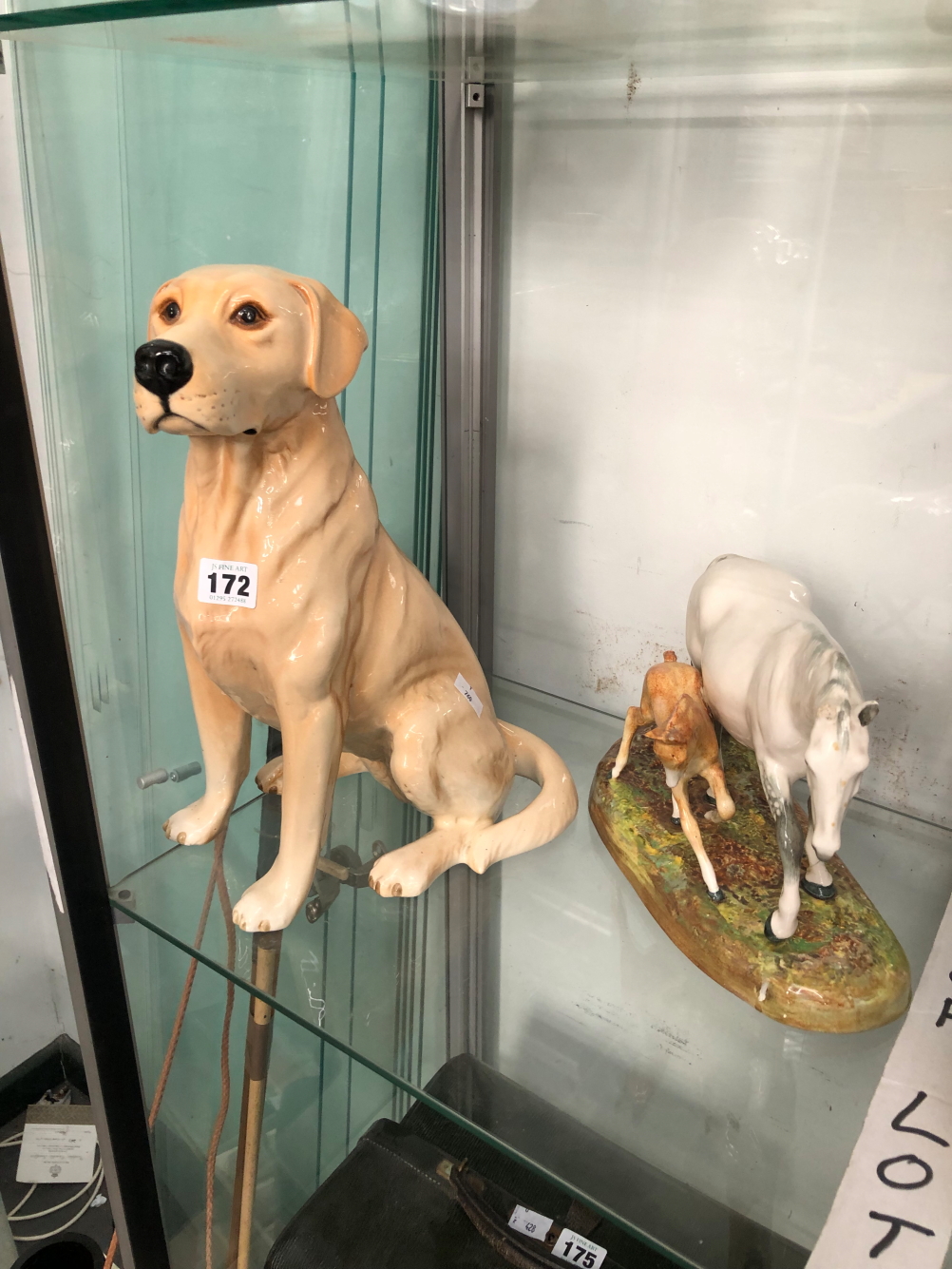 A BESWICK SEATED LABRADOR TOGETHER WITH A DOULTON MARE AND FIOAL