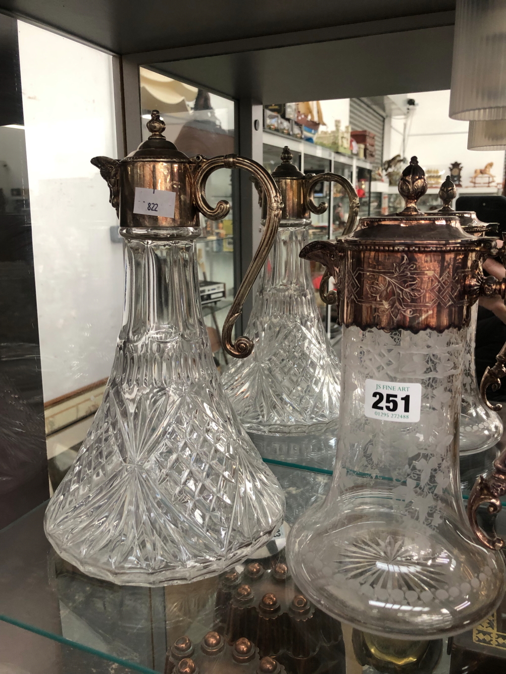TWO ELECTROPLATE MOUNTED CLARET JUGS, ONE WHEEL ENGRAVED WITH VINE FOLIAGE