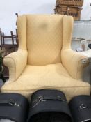AN ANTIQUE WING BACK ARMCHAIR