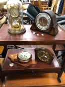 AN ANTIQUE BRASS ANNIVERSARY CLOCK AND THREE OTHERS.