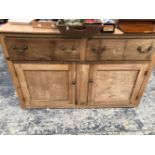 AN OAK DRESSER WITH TWO DRAWERS OVER TWO DOORS. W 142 x D 47 x H 91cms