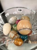 A COLLECTION OF STONE EGG HAND COOLERS IN A CRISTAL D'ARQUES GLASS BOWL
