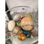 A COLLECTION OF STONE EGG HAND COOLERS IN A CRISTAL D'ARQUES GLASS BOWL