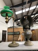 AN OIL LAMP WITH A METAL REFLECTOR SHADE TOGETHER WITH A TABLE LAMP ADJUSTABLE ON A COLUMN AND