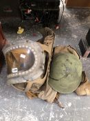 A WWII SOLDIERS GAS MASK AND HELMET