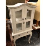 A SMALL PAINTED GLAZED CABINET ON STAND.
