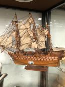 A WOODEN MODEL THREE MASTED MAN OF WAR IN FULL SAIL
