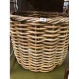 A LARGE WICKER LOG BASKET.