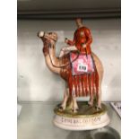 A STAFFORDSHIRE POTTERY FIGURE OF GENERAL GORDON RIDING A CAMEL