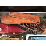A GUN CASE A LEATHER CARTRIDGE BAG A LEATHER GUN SLIP ONE OTHER AND THREE CARTRIDGE BELTS.