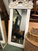 A LARGE PAINTED FRAMED MIRROR
