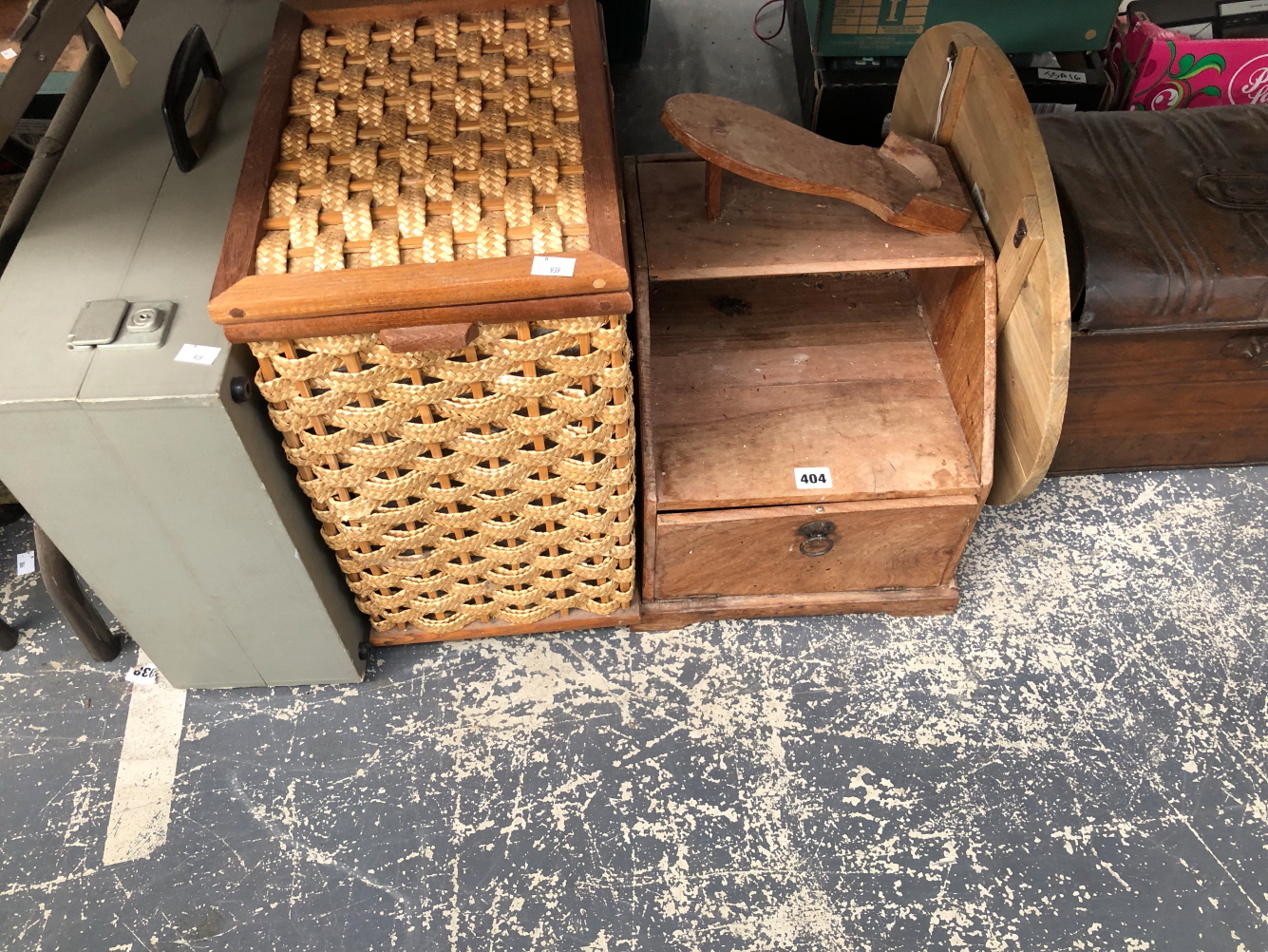 A SHOE CLEANING WOODEN BOX, 2 BASKETS, A TIN TRUNK, AN OTTOMAN FOOTSTOOL, A CHEESE BOARD, ETC